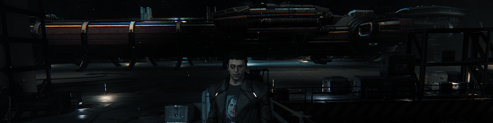 A man standing in front of one of the tramp steamers of space; landed in an in-ground hangar.